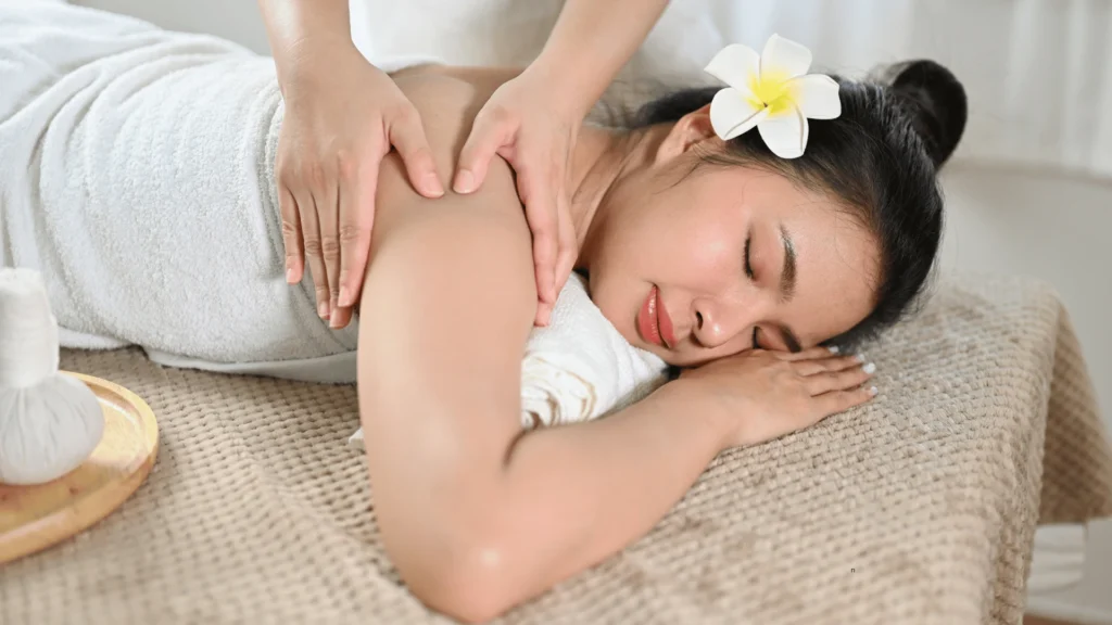 Person receiving a back massage focused on relieving muscle tension and stress.