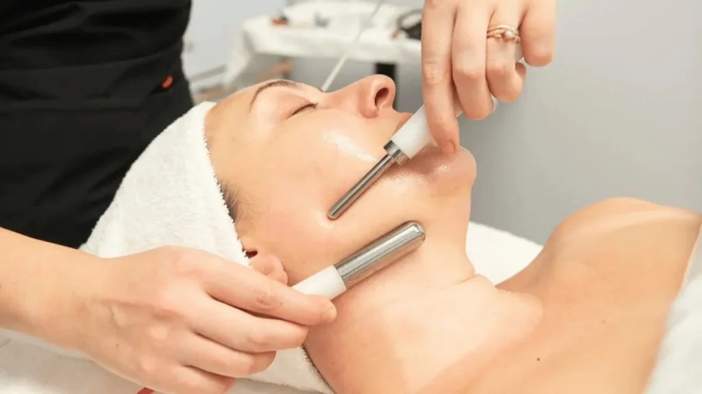 Woman receiving a microcurrent facial treatment to lift and tone facial muscles for a youthful appearance.